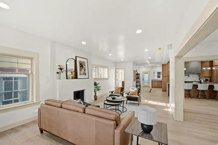 Open-concept living area featuring light wood-finish flooring and recessed lighting