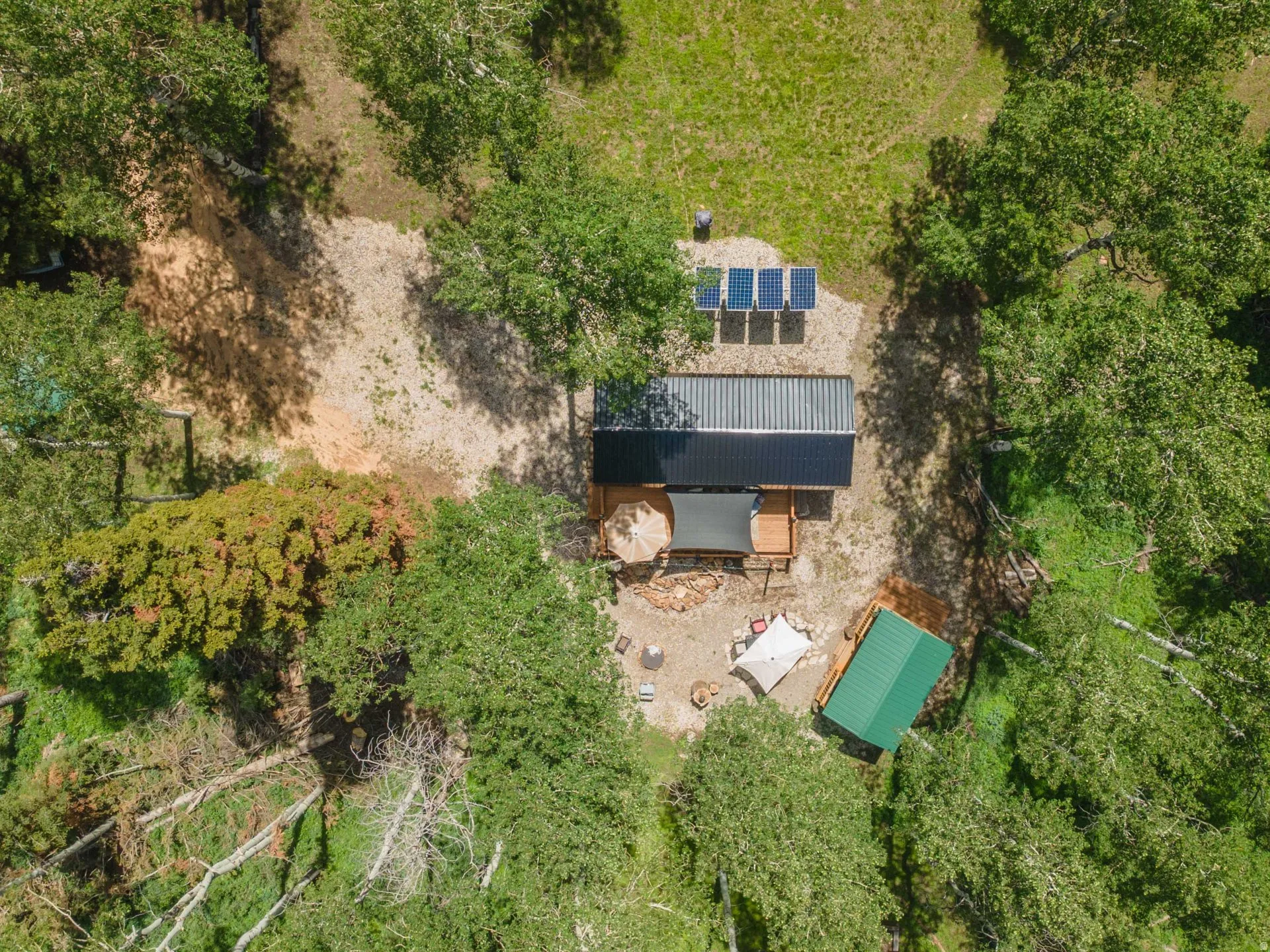 Aerial property perspective featuring a wooded landscape