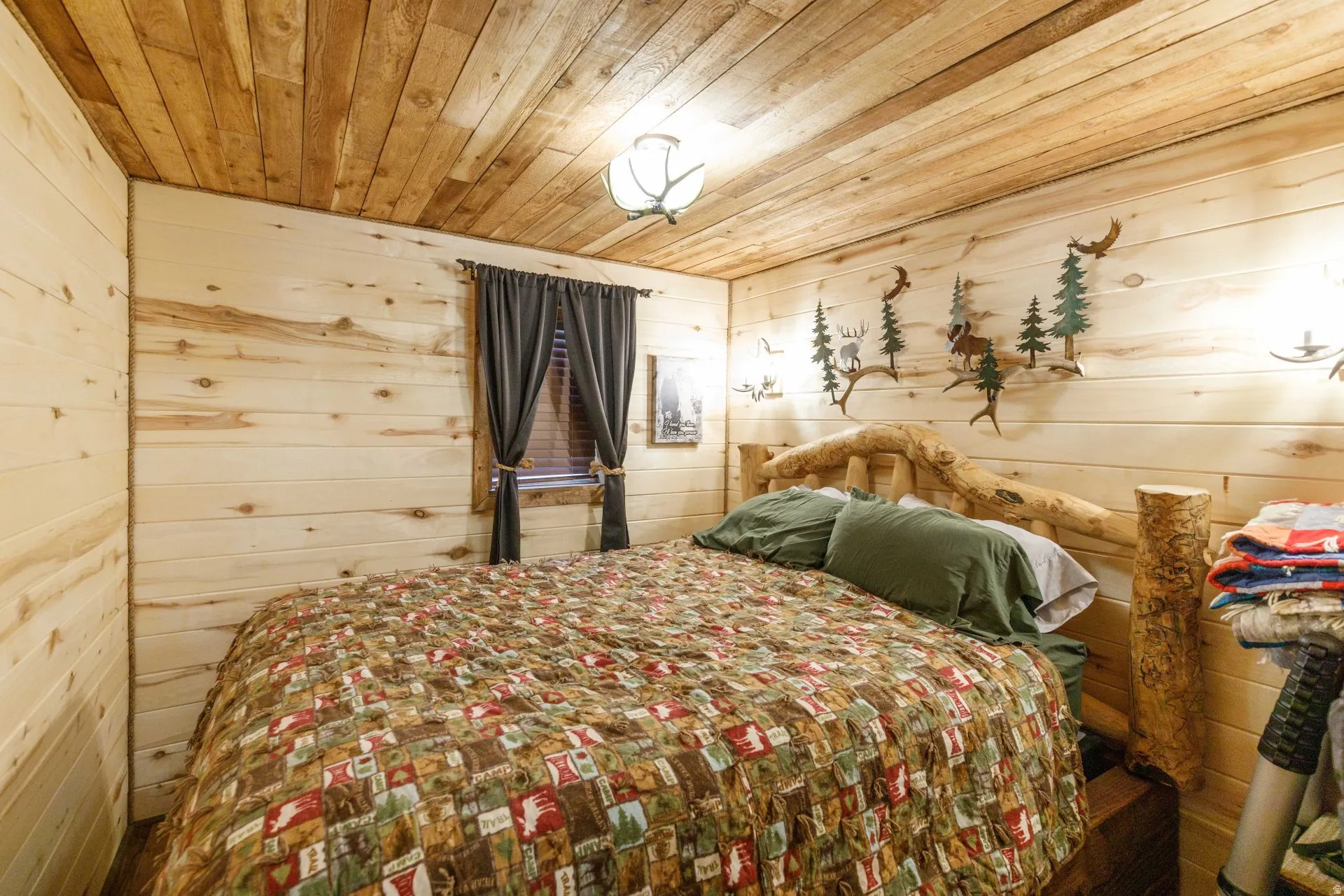 Room featuring natural wood plank walls and a complementary wood plank ceiling