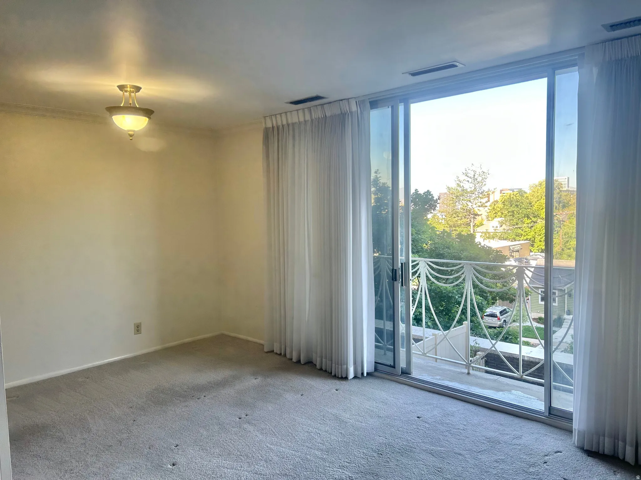 Sliding glass doors opening to a balcony with decorative railing