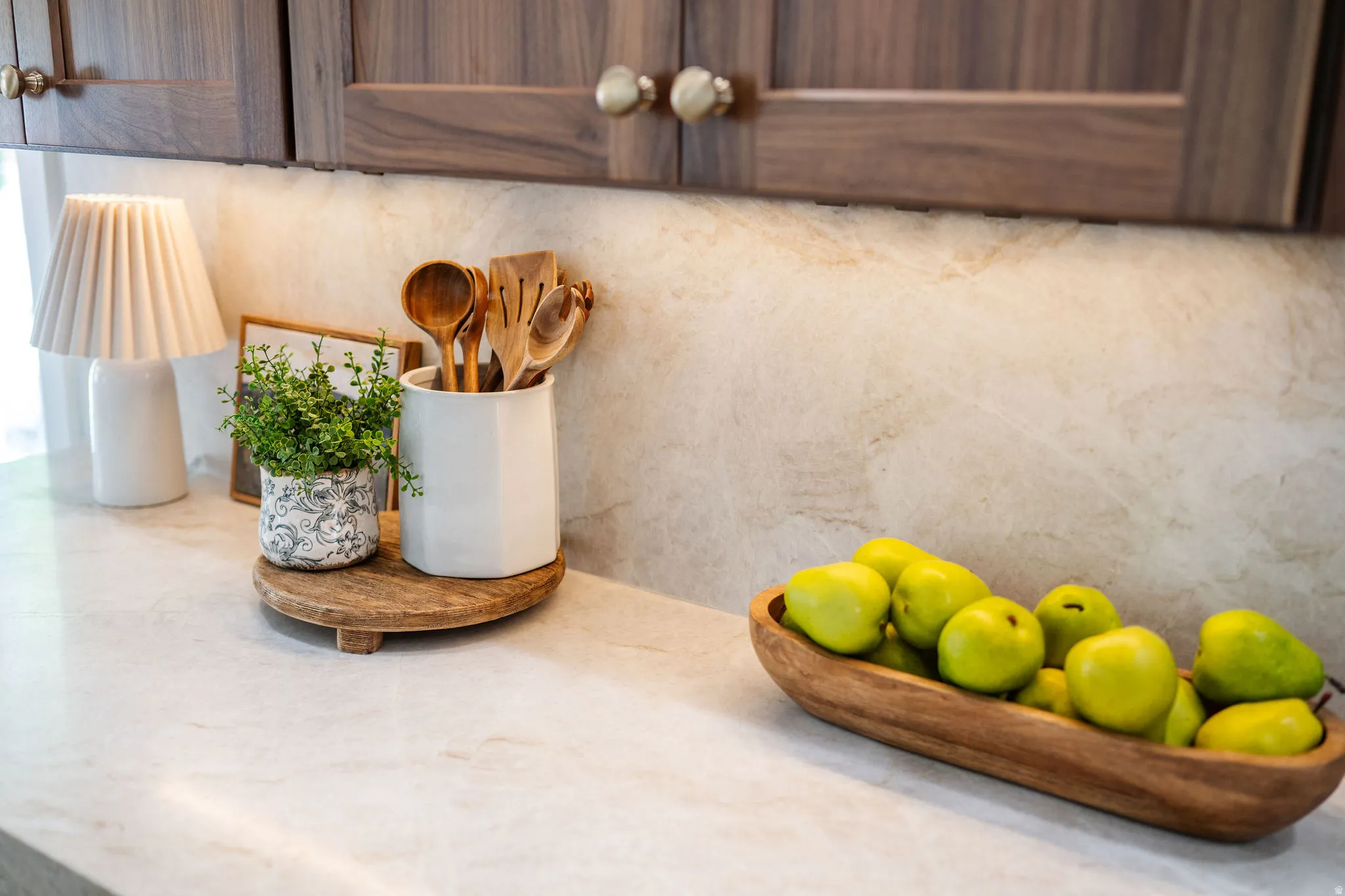 Kitchen countertop featuring a light-toned surface and a complementary backsplash