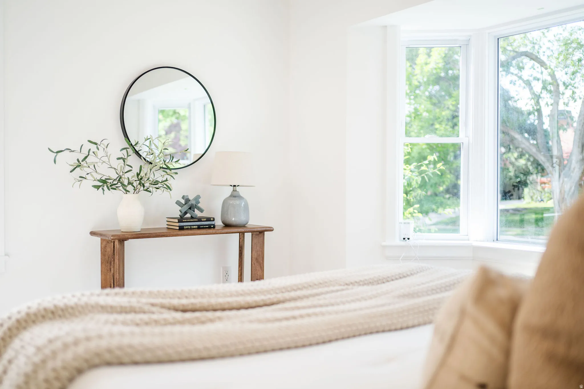 Bright bay window providing natural light, complemented by neutral wall finishes