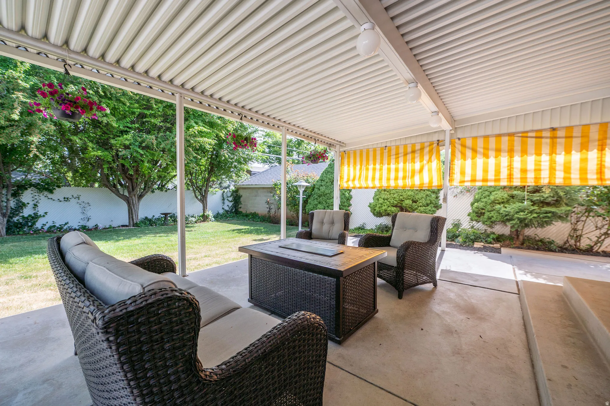 Covered patio featuring a corrugated metal roof and concrete flooring