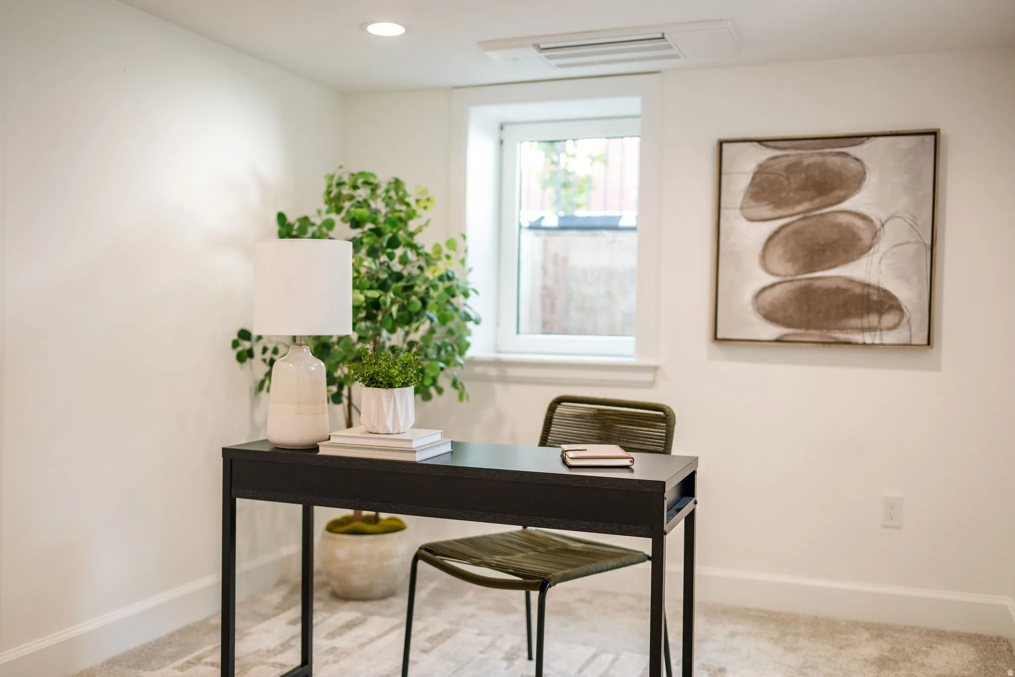 Recessed lighting illuminates a neutral-toned room featuring a white window with a deep sill