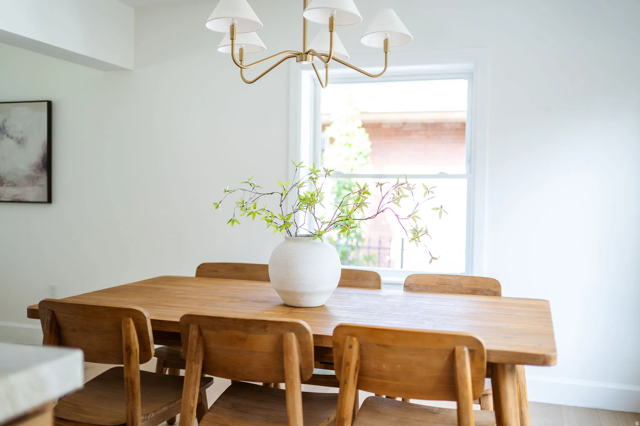 Dining area featuring a single window, white walls, and light wood-finish flooring