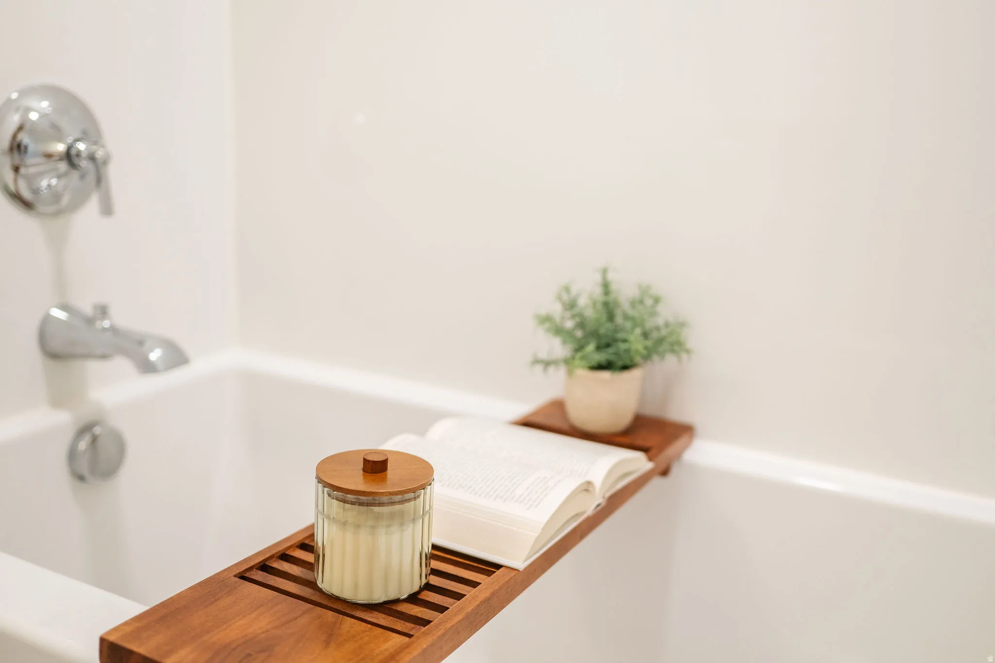 White alcove bathtub with chrome fixtures