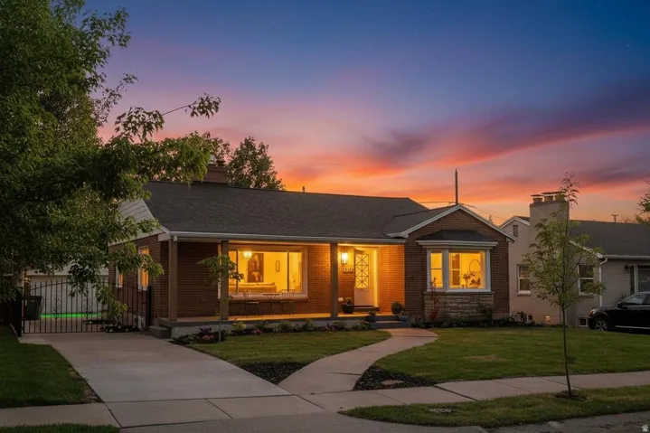 Brick exterior with a covered front porch and stone accents