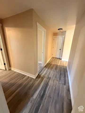 Wood-finish flooring throughout the hallway