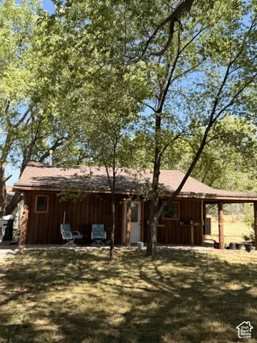 Wood-sided exterior featuring multiple mature trees