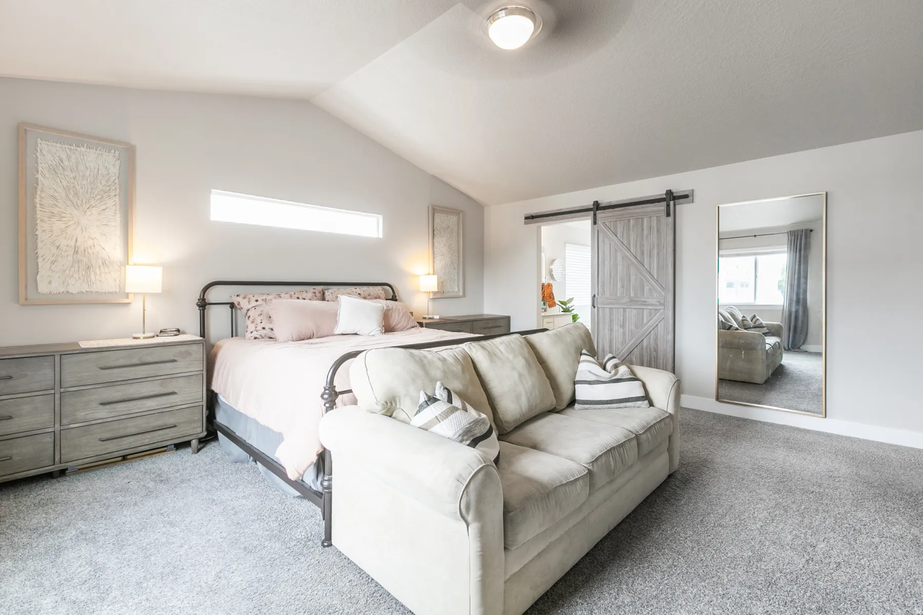 Carpeted room featuring a vaulted ceiling with a flush-mount light fixture