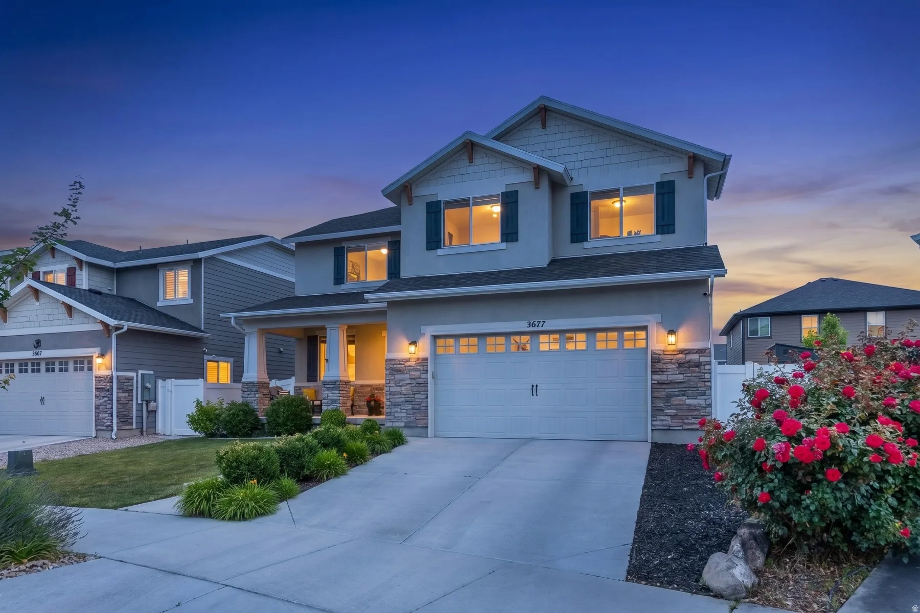 Two-story residence featuring a stone-accented facade and covered front porch