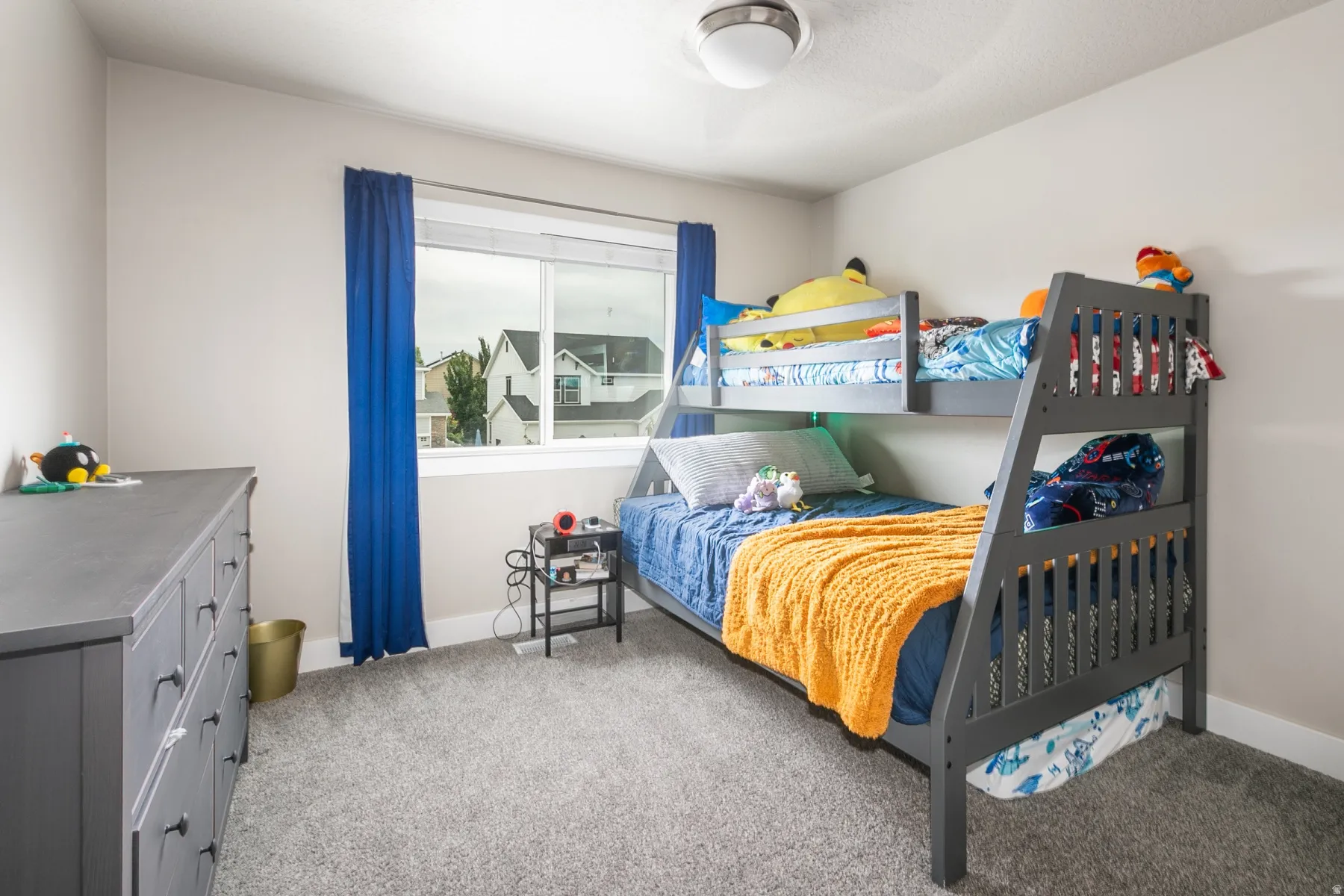 Carpeted room featuring a large window with white trim, a recessed ceiling light fixture, and a built-in bunk bed frame