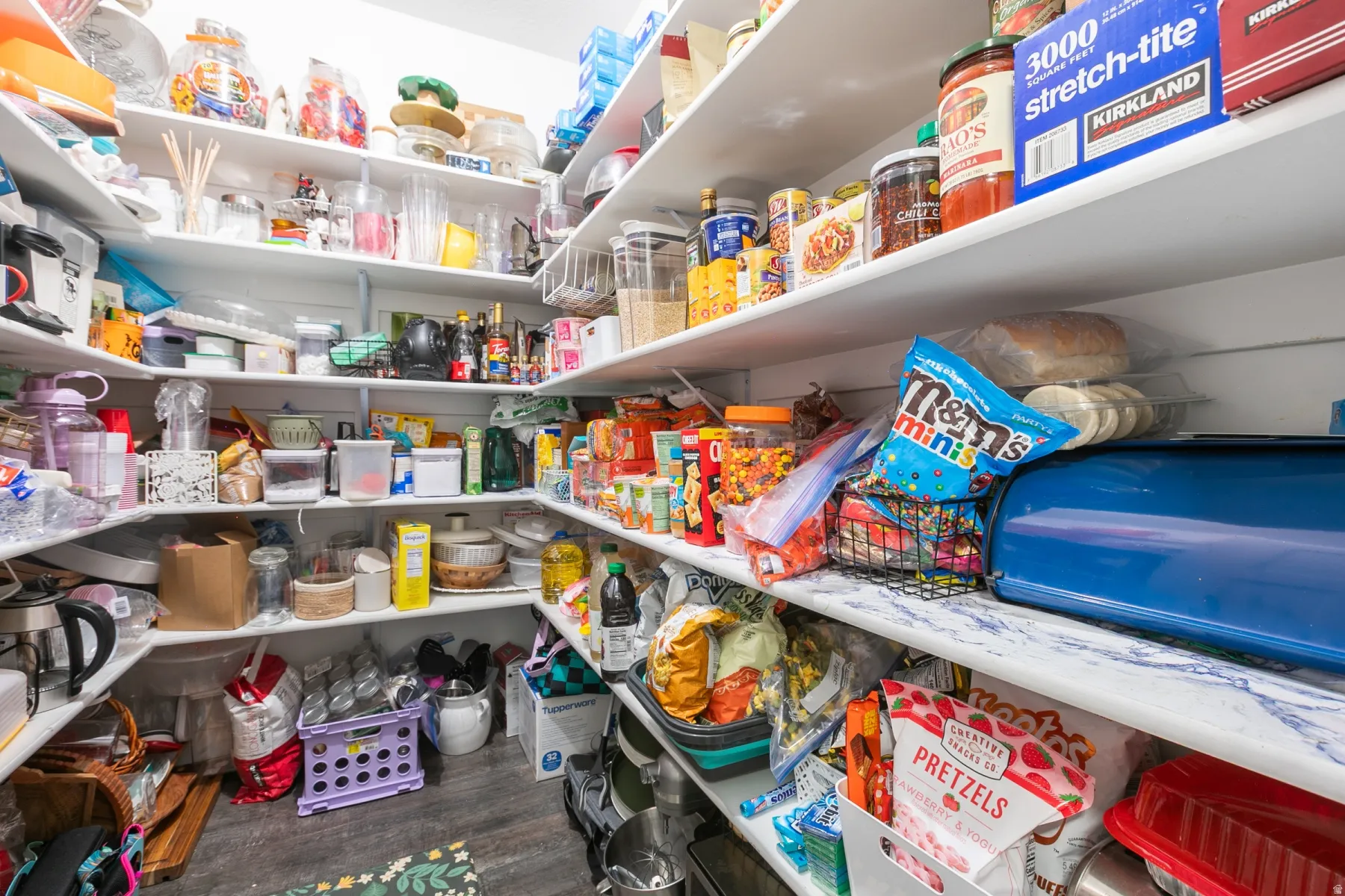 Walk-in pantry featuring extensive built-in shelving, providing ample storage capacity