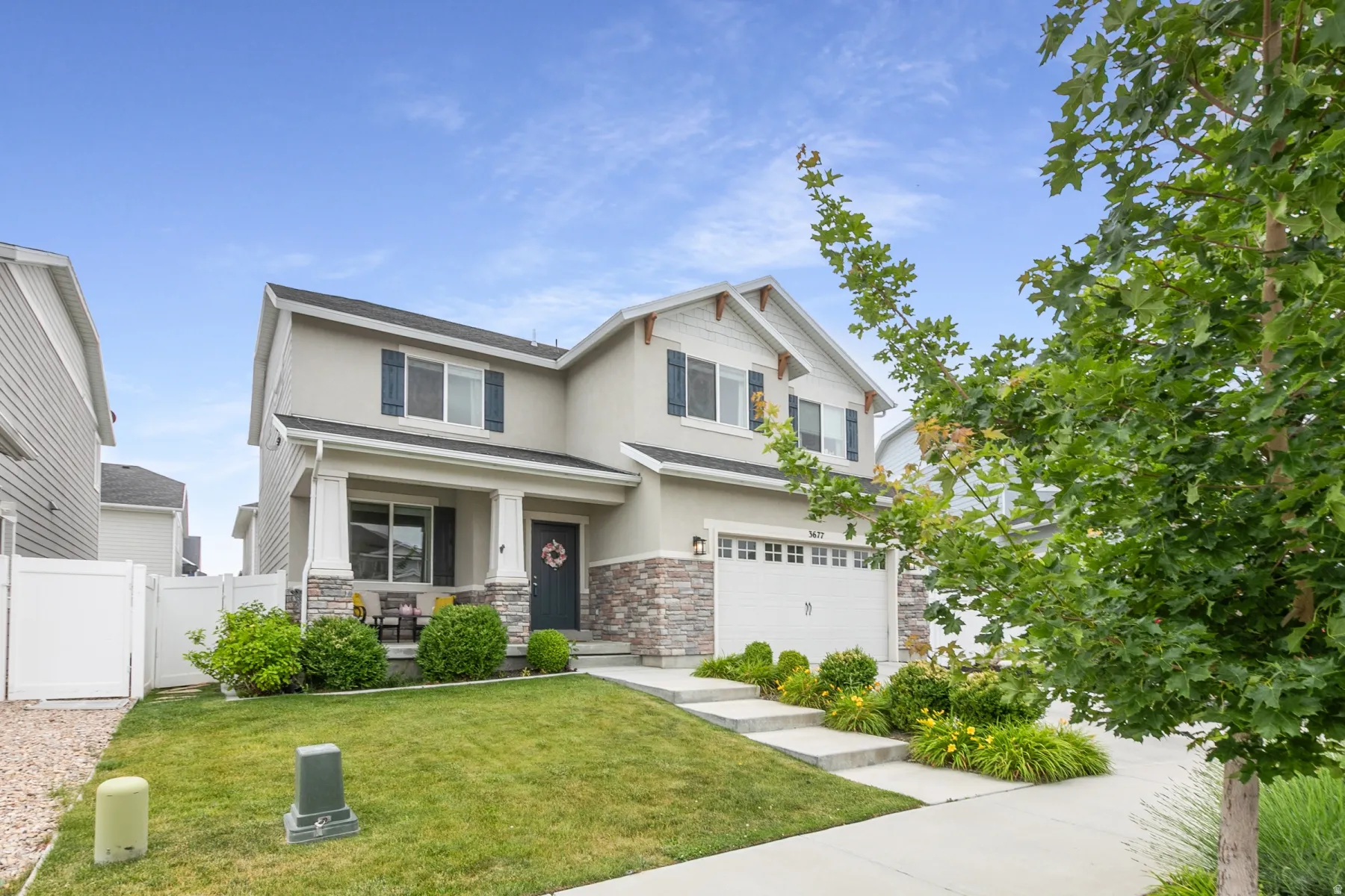 Modern two-story residence featuring a stone and stucco facade
