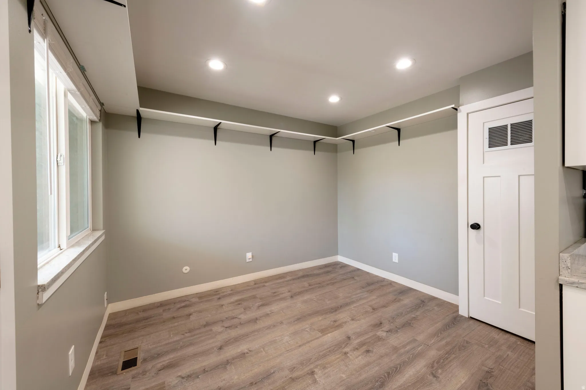 Contemporary interior space featuring wood-finish flooring and recessed lighting