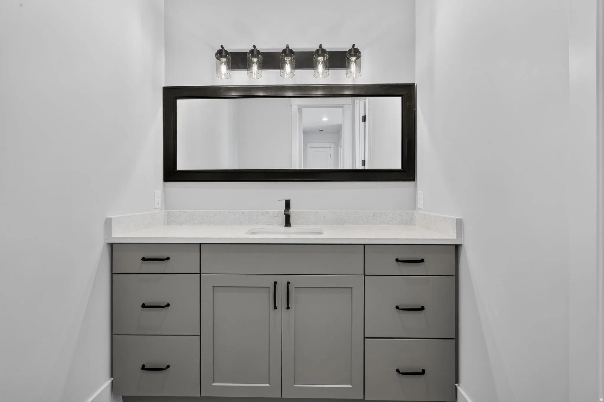 Contemporary vanity featuring a light gray finish, solid surface countertop, and undermount sink