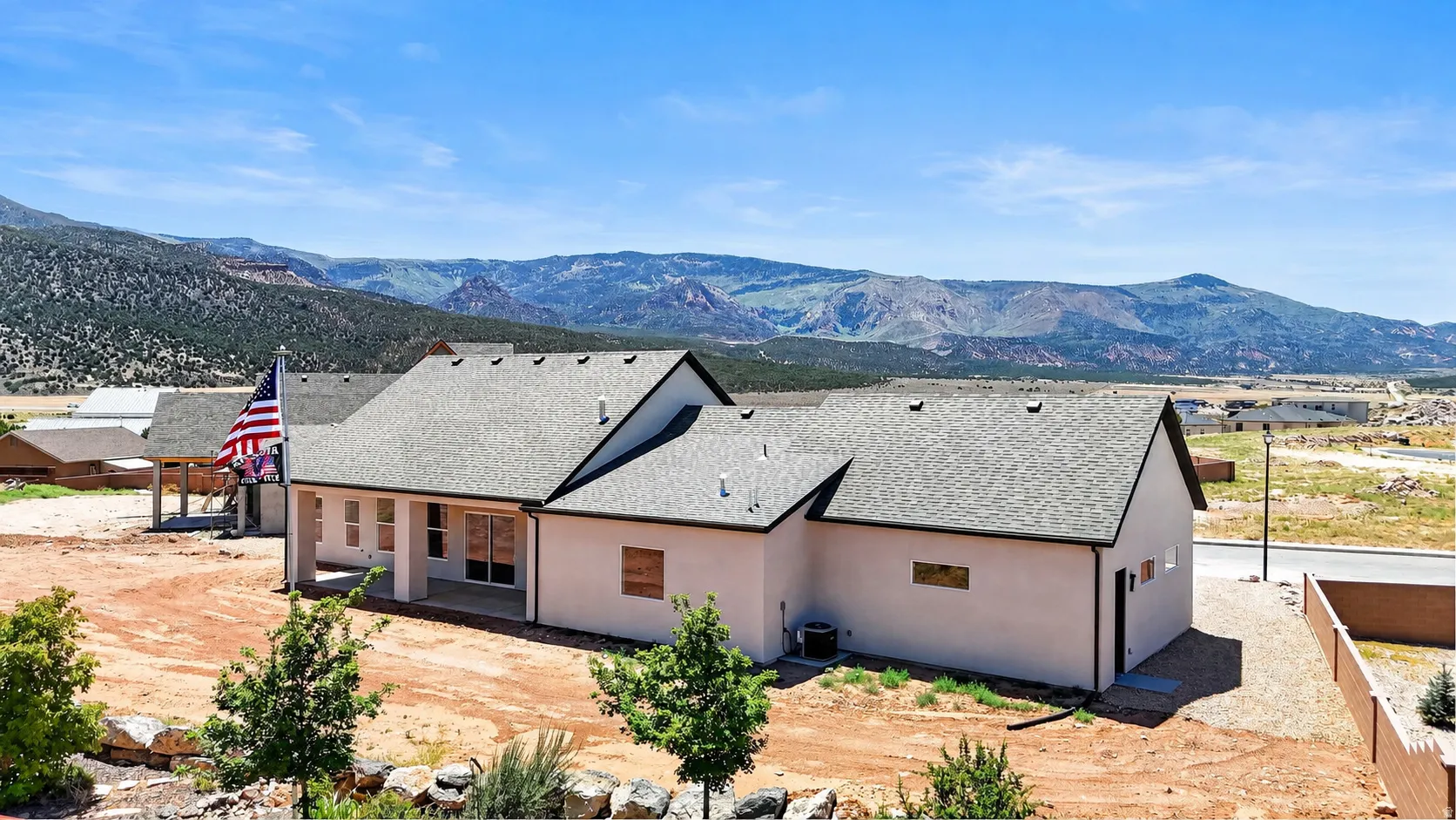 Contemporary single-story residence with a light stucco exterior and dark trim