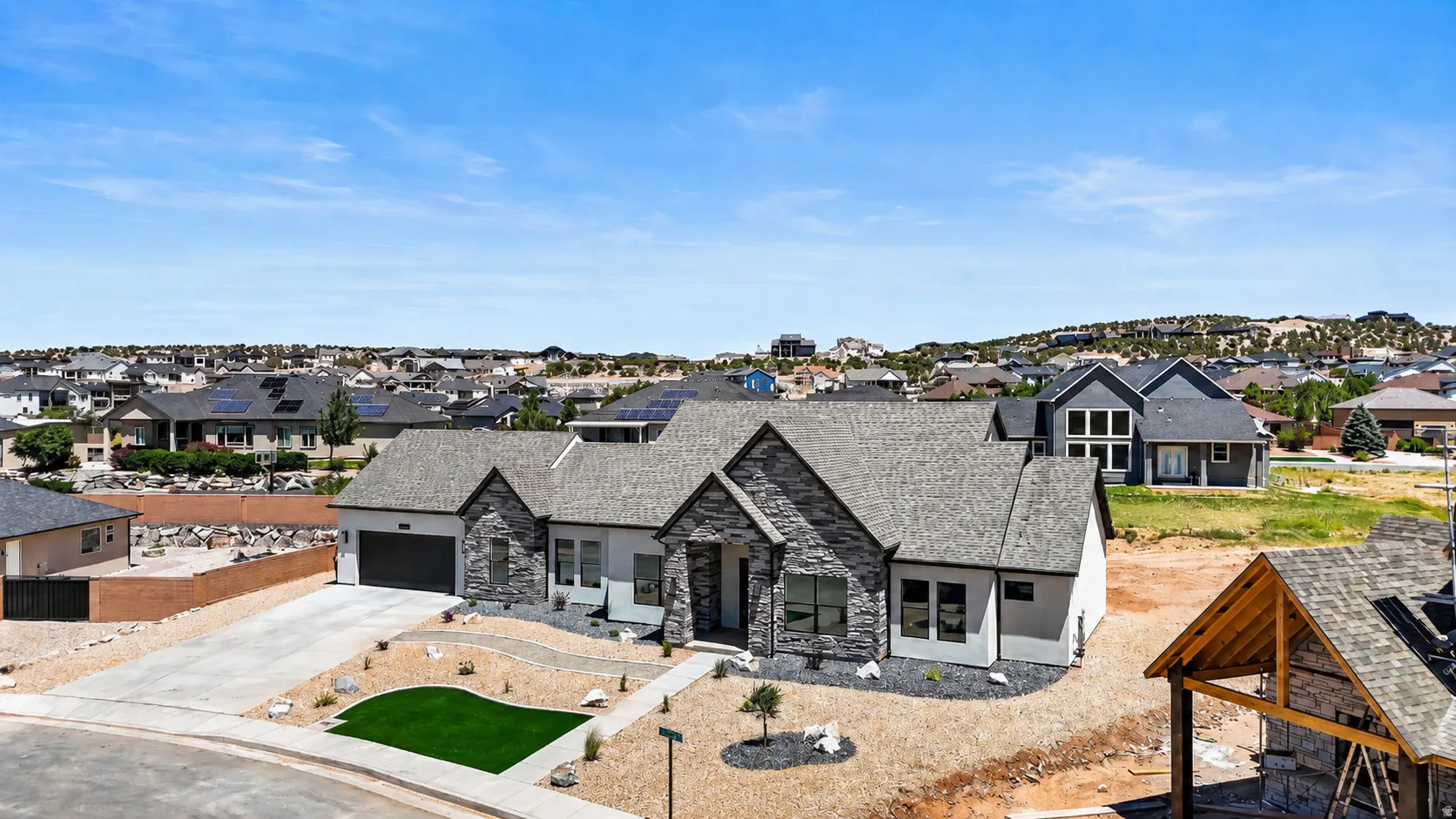 Contemporary single-story residence featuring a stone and stucco exterior