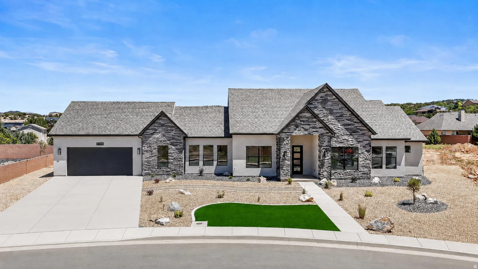 Contemporary single-story residence with a multi-gabled roofline and a stone facade accent