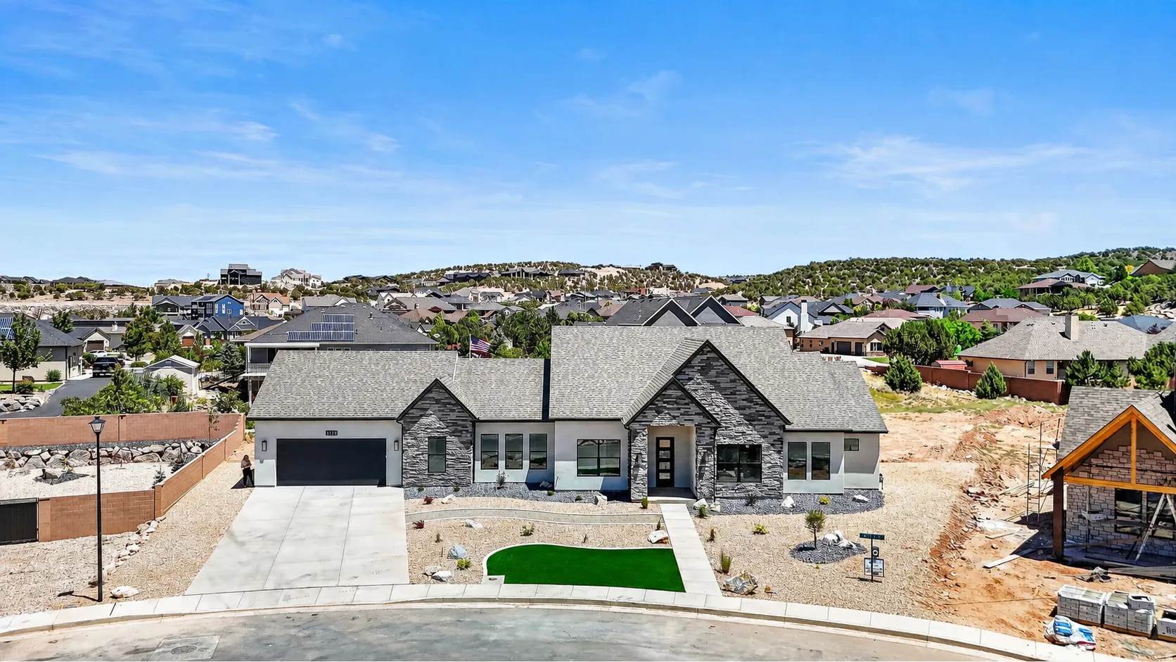 Modern exterior with stone accents and a gray roofline