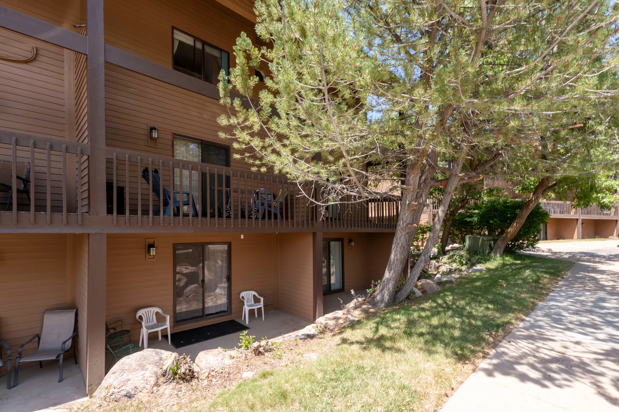 Multi-level building exterior featuring horizontal siding and dark trim