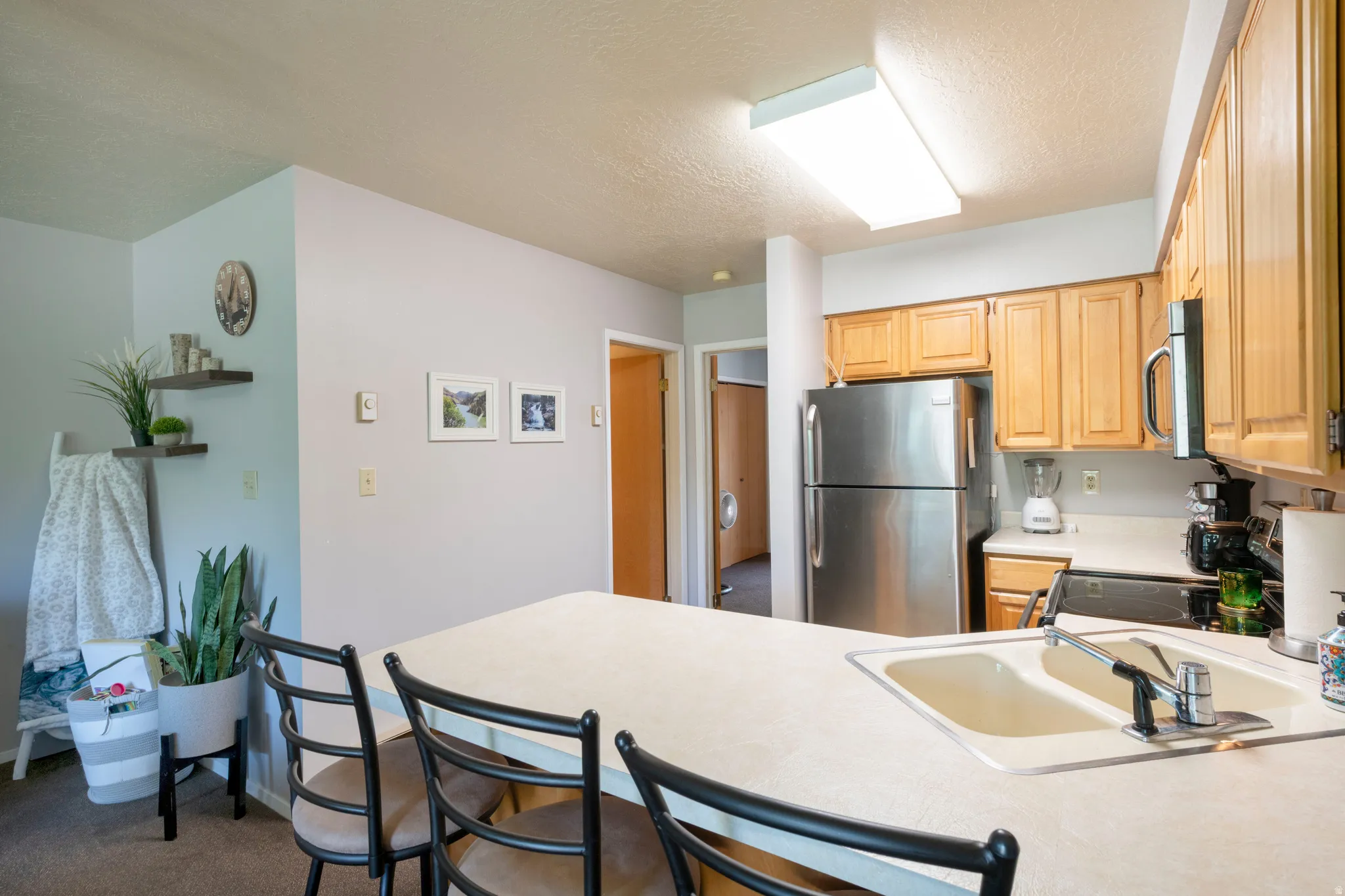 Kitchen featuring wood cabinetry and white countertops