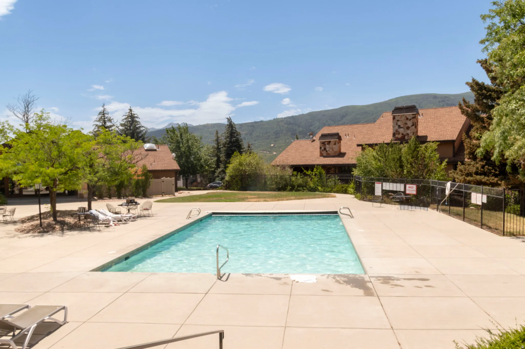 Rectangular outdoor pool with concrete surround