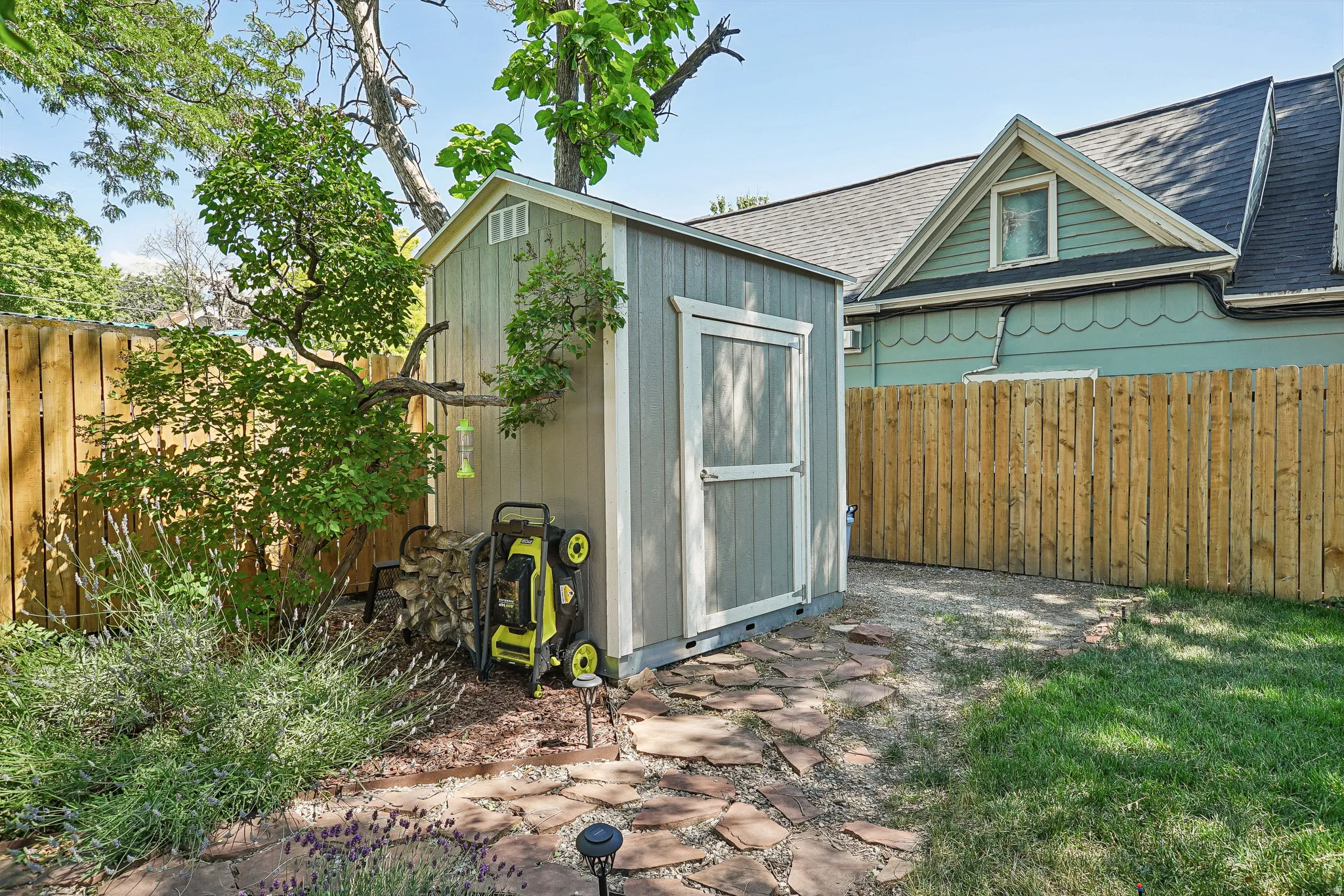 Freestanding storage shed with wood-finish siding and a gable roofline