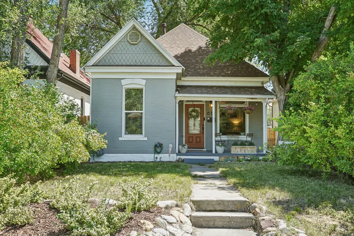 Charming single-story residence featuring a covered front porch and a prominent front-facing gable with decorative shingles