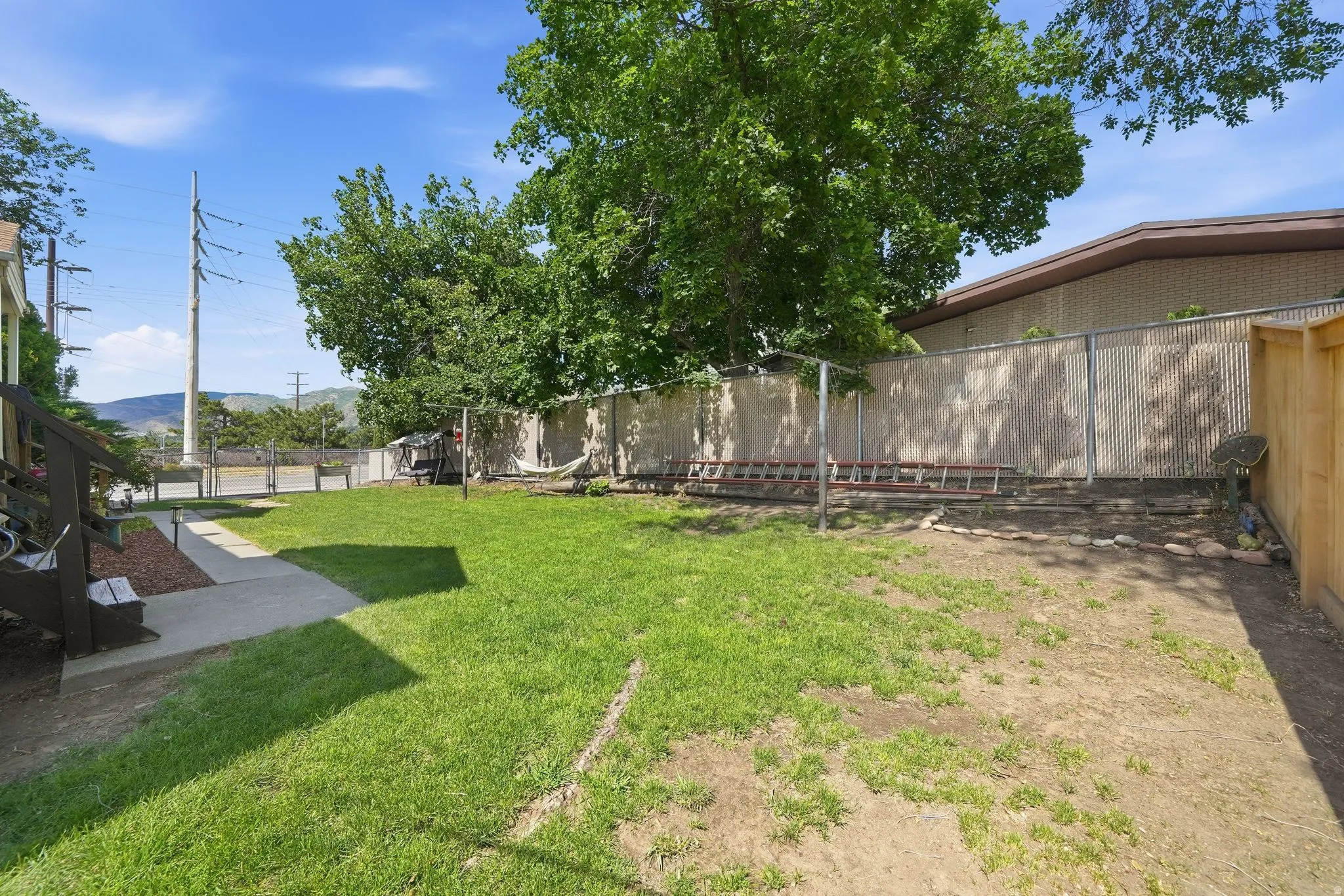 Expansive backyard with a combination of manicured lawn and natural groundcover