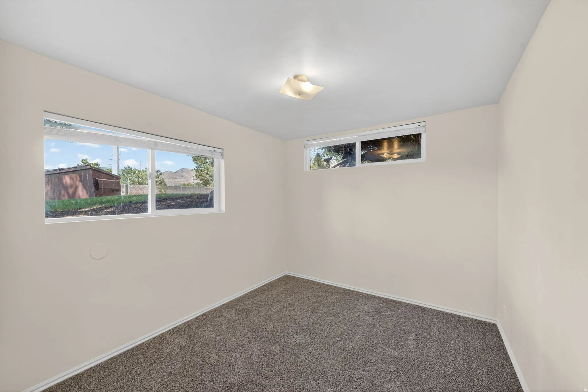 Neutral-toned walls complement the gray carpeting