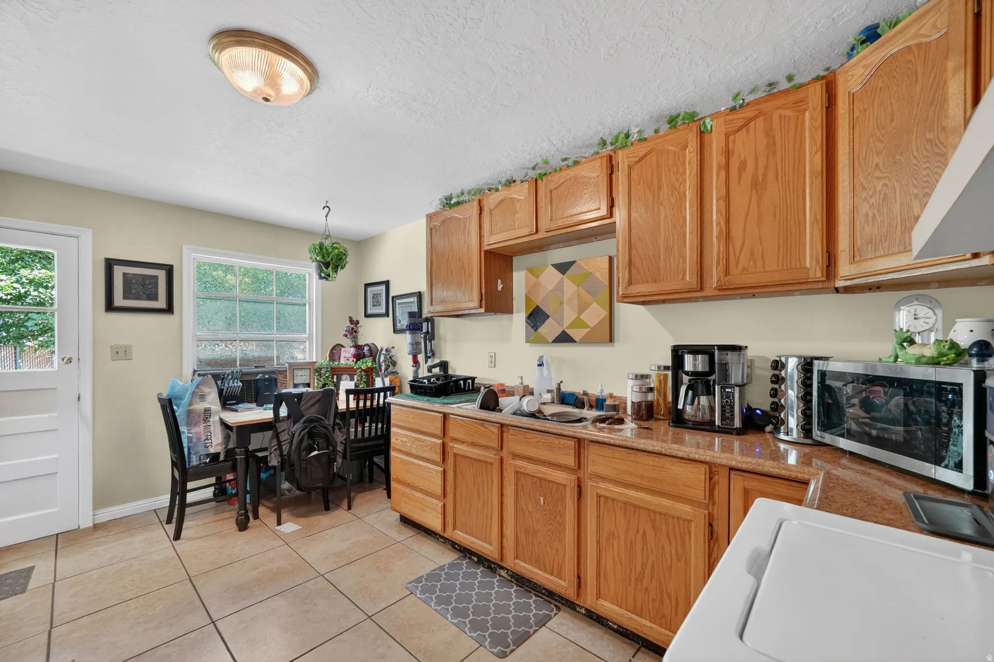 Kitchen featuring wood-finish cabinetry and a light-toned countertop
