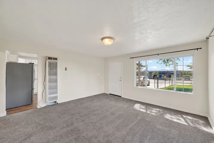 Living area with gray carpeting and white walls