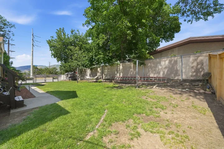 Expansive backyard with a combination of manicured lawn and natural groundcover