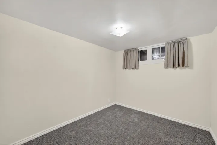 Room featuring neutral wall finishes and gray carpet flooring