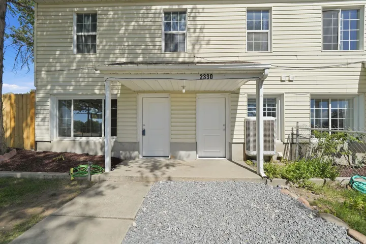Two-story exterior with light-colored siding
