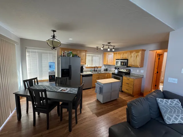 Open concept kitchen and dining area with wood-finish flooring