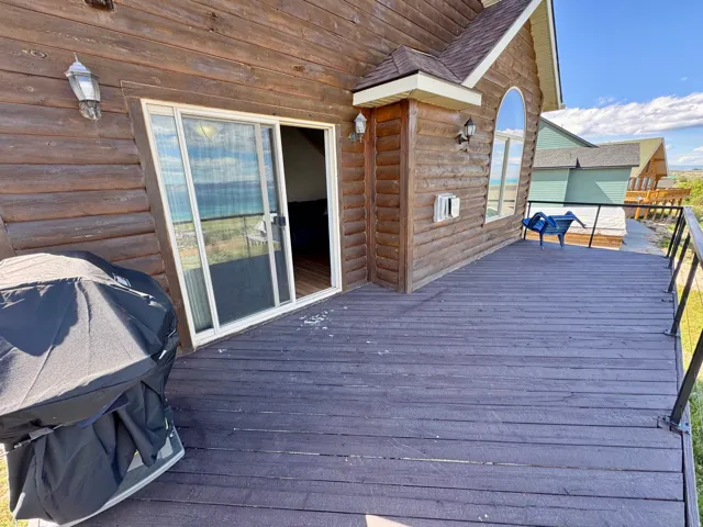 Expansive outdoor deck with a dark wood-finish surface