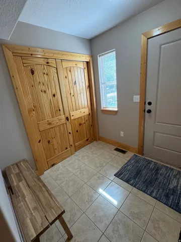 Entry area featuring light-toned tile flooring and painted walls
