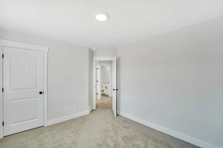Photos are of a previously built home of the same floor plan. Finishes, colors, features, and upgrades may vary. Neutral wall paint, recessed ceiling lighting, light carpet flooring, white baseboards, and white paneled interior doors with black hardware