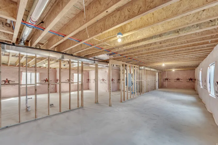 Photos are of a previously built home of the same floor plan. Finishes, colors, features, and upgrades may vary. Unfinished lower level featuring concrete flooring, exposed wood joists, and framed interior walls
