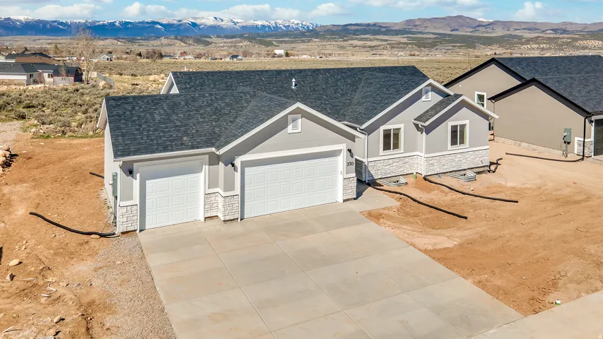 Photos are of a previously built home of the same floor plan. Finishes, colors, features, and upgrades may vary.Contemporary ranch-style residence featuring a light gray exterior with white stone veneer accents