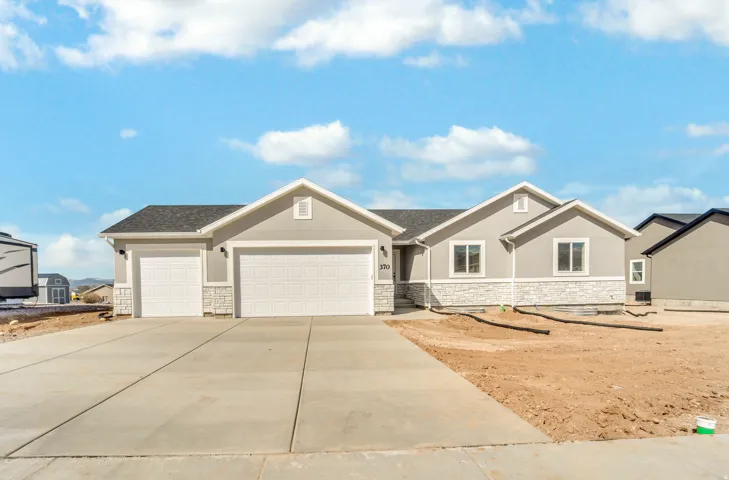 Photos are of a previously built home of the same floor plan. Finishes, colors, features, and upgrades may vary.Contemporary ranch-style home featuring a light gray stucco exterior and white stone veneer accents