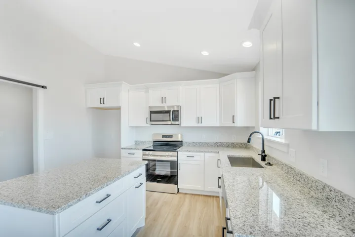 Photos are of a previously built home of the same floor plan. Finishes, colors, features, and upgrades may vary. Modern kitchen featuring white cabinetry and light-toned countertops