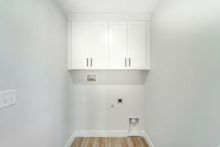 Photos are of a previously built home of the same floor plan. Finishes, colors, features, and upgrades may vary. Laundry area with overhead white shaker-style cabinetry featuring dark hardware