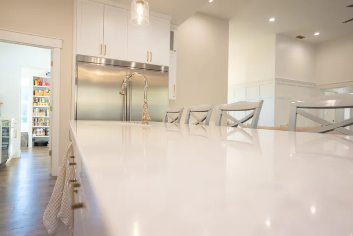 Expansive kitchen island featuring a polished white countertop