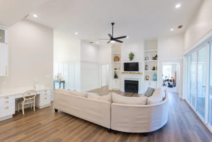 Spacious living area featuring high vaulted ceilings, wood-finish flooring, and recessed lighting