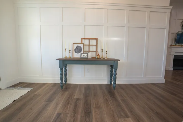 White board and batten accent wall with dark wood-finish flooring