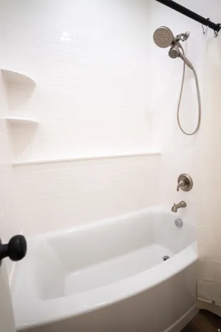 Bathtub with white subway tile surround