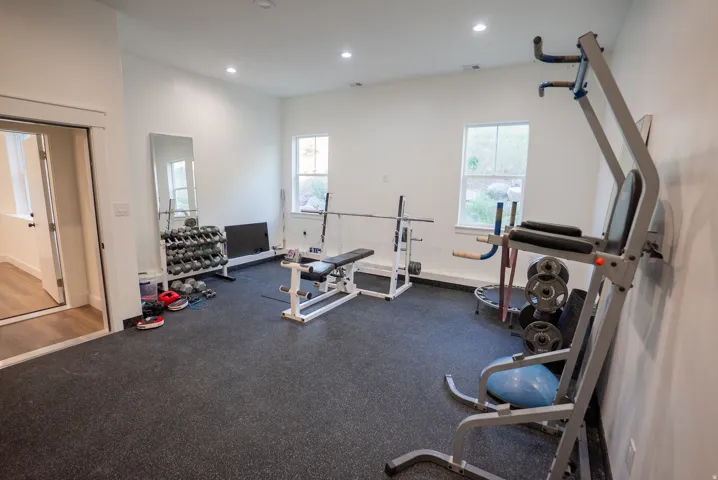 Dedicated room featuring robust rubber flooring, recessed lighting, and two windows